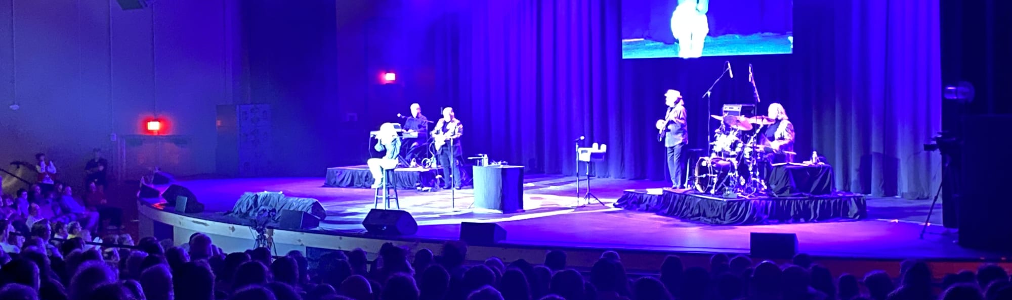 signer on stage in chair washed out by the lights Fort Myers